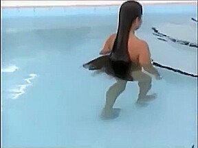 A woman of the long hair enters the pool