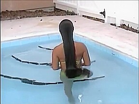 A woman of the long hair enters the pool