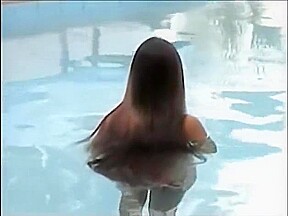 A woman of the long hair enters the pool