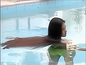 A woman of the long hair enters the pool