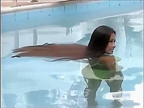 A woman of the long hair enters the pool