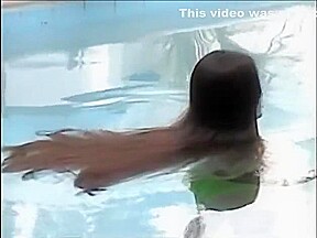 A woman of the long hair enters the pool