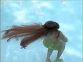 A woman of the long hair enters the pool
