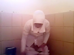 Arab woman goes pee in a public toilet