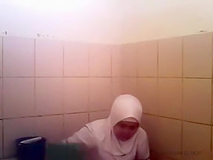 Arab woman goes pee in a public toilet