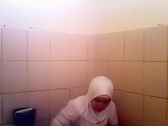 Arab woman goes pee in a public toilet