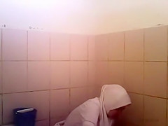 Arab woman goes pee in a public toilet