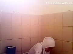 Arab woman goes pee in a public toilet