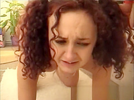 Attractive redhead with lovely tits bends over and gets spanked hard