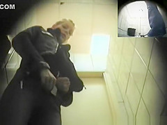Blonde girl in tight jeans pants peeing