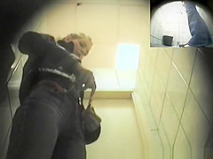 Blonde girl in tight jeans pants peeing