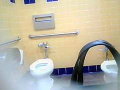 Bootylicious black MILF pees in a restroom