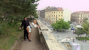 Busty blonde gives double blowjob in public