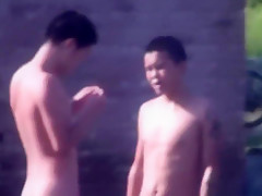 Chinese Men swimming at lake