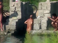 Chinese Men swimming at lake