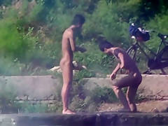 Chinese Men swimming at lake