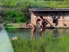 Chinese Men swimming at lake