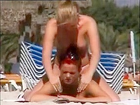 Deux copines topless simulent de baiser sur la plage
