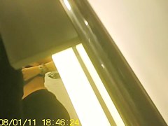 Girl in fitting room posing in new top before mirror