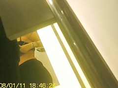 Girl in fitting room posing in new top before mirror