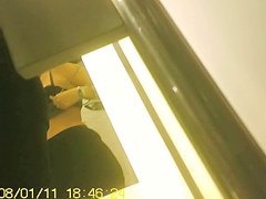 Girl in fitting room posing in new top before mirror
