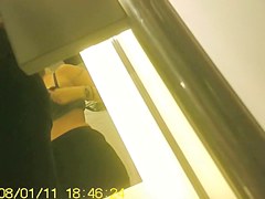 Girl in fitting room posing in new top before mirror
