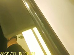 Girl in fitting room posing in new top before mirror