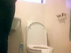Girl in glasses spied taking a piss