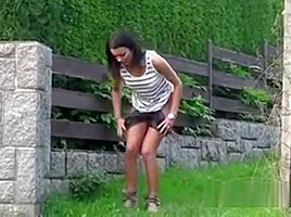 Half Naked Brunette Pissing Behind A Building
