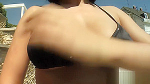 Horny Honey Lovely oils up her big titties outside