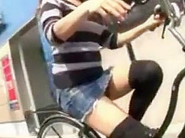 Japanese girl rides a bike with short skirt in streets