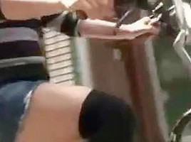 Japanese girl rides a bike with short skirt in streets