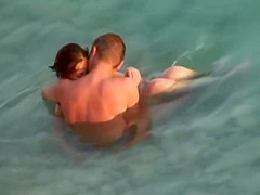 Kama Sutra on the beach Couples have sex in the sea