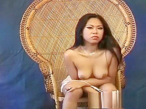 Miki Chan poses on and by her wicker chair showing nice skin