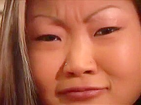 Rampant Asian Lucy Lee gives a seducing walk around room then sucks cock