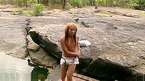 Redhead ladyboy shows off tiny tits and strokes small cock