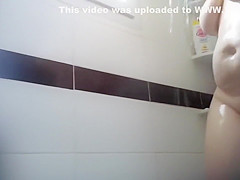 Saucy cougar with large saggy breasts gets caught on tape taking a shower
