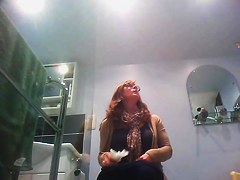 Sexy milf looking around when pissing on the toilet