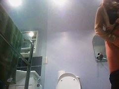 Sexy milf looking around when pissing on the toilet