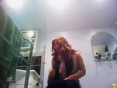 Sexy milf looking around when pissing on the toilet