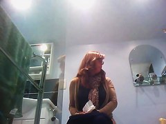 Sexy milf looking around when pissing on the toilet