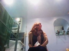 Sexy milf looking around when pissing on the toilet