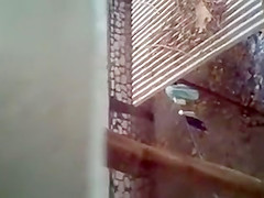 Spying on a topless girl showering outdoors