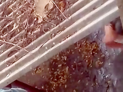 Spying on a topless girl showering outdoors