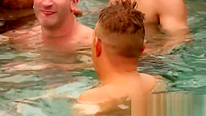 Swinger couples play slippery melon naked in the swiming pool as a warm up foreplay game