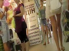 Tanned butt under a short white skirt
