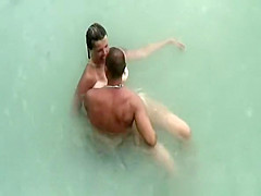 Tattooed nudist fucked in the water