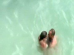 Tattooed nudist fucked in the water