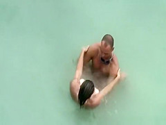 Tattooed nudist fucked in the water