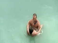 Tattooed nudist fucked in the water